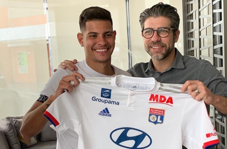 Ao lado de Juninho, Bruno Guimarães posa para foto com camisa do Lyon